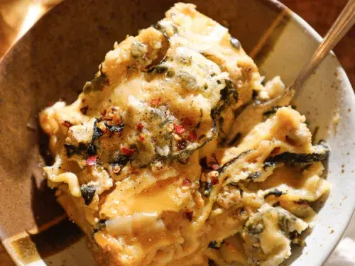 bowl with cheesy white lasagna made in the slow cooker.