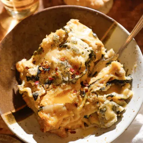 bowl with cheesy white lasagna made in the slow cooker.