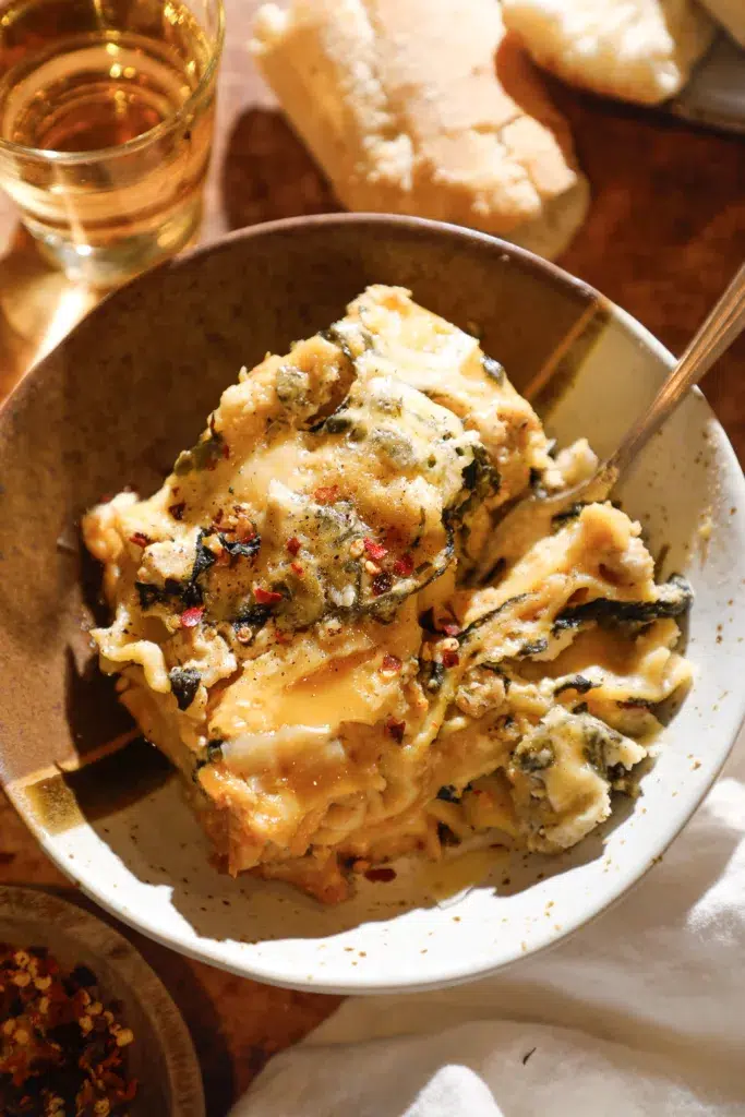 bowl with cheesy white lasagna made in the slow cooker.
