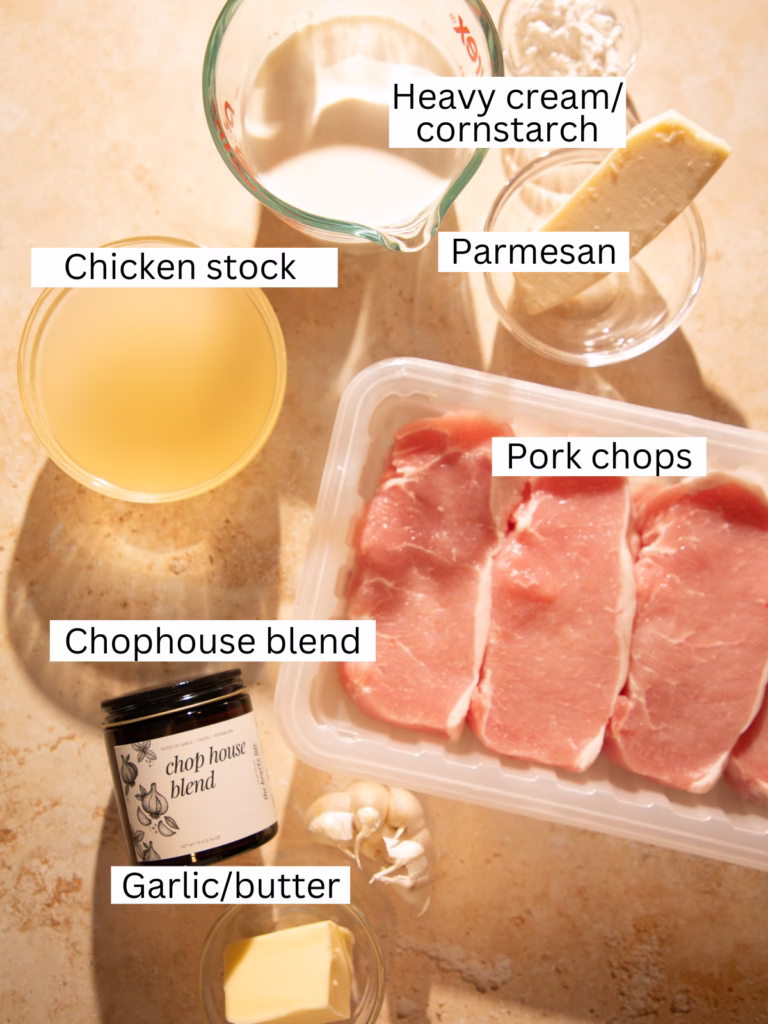 Ingredients for peppercorn crusted pork chops including pork chops, heavy cream, chicken stock, parmesan, garlic, butter, and Chophouse Blend seasoning.