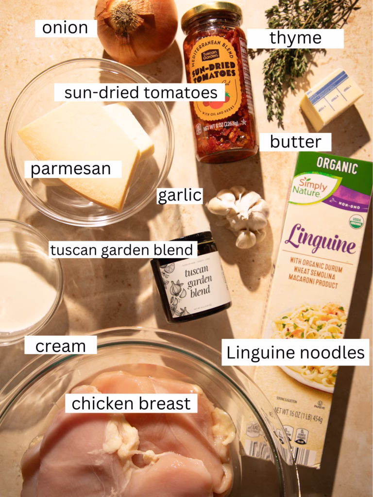 Ingredients for creamy Tuscan chicken pasta with sun-dried tomatoes, parmesan, garlic, onion, linguine, cream, and Tuscan Garden seasoning.